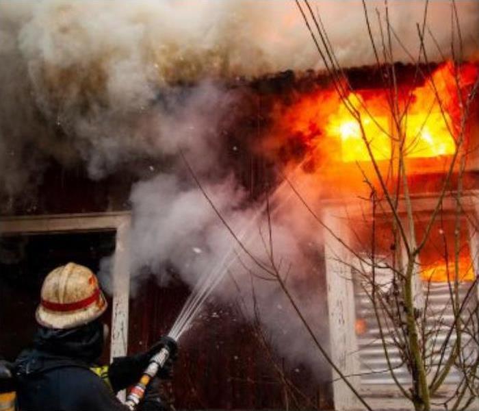 Firefighter Tackling Massive House Fire